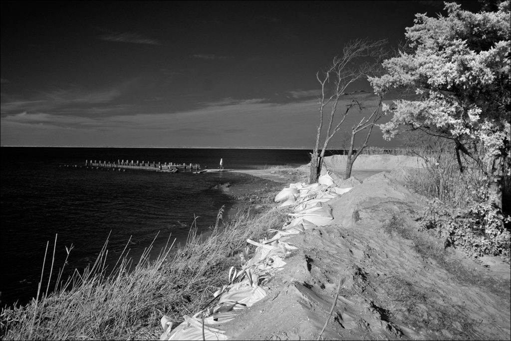 Within weeks, protective berms are destroyed by wind and waves