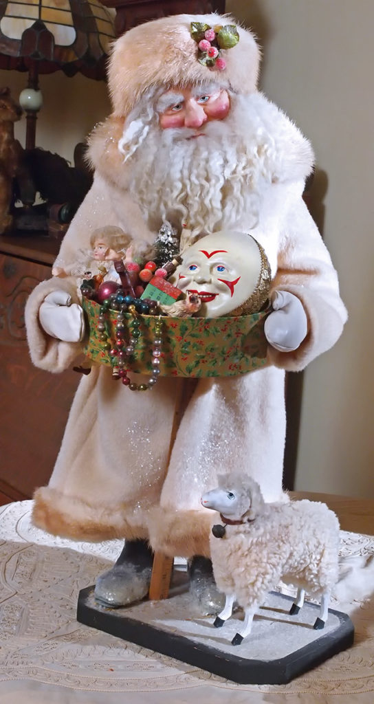 A custom-made Carpenter Santa figure with a basket of Christmas toys.